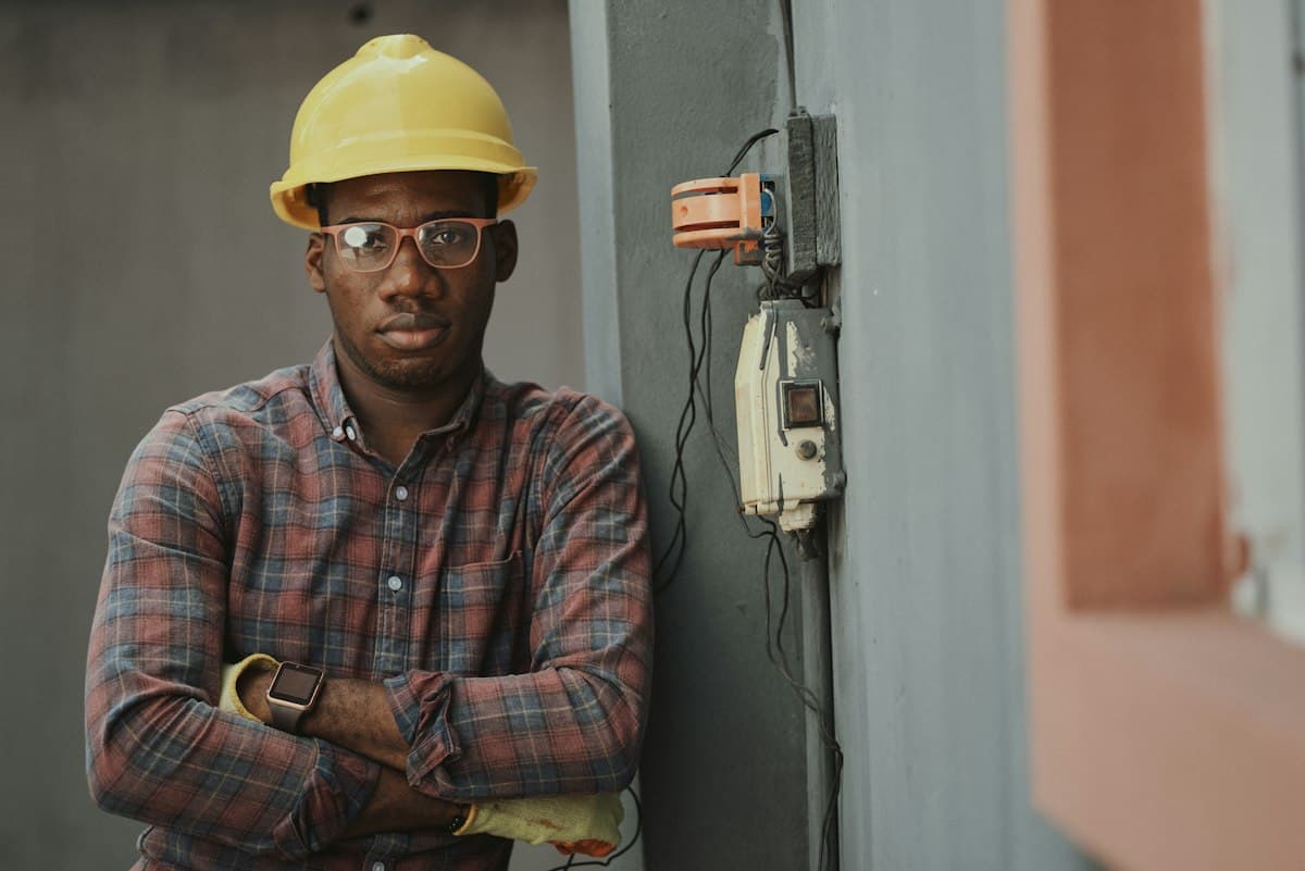 Technician wearing a hard hat, safety glasses and gloves