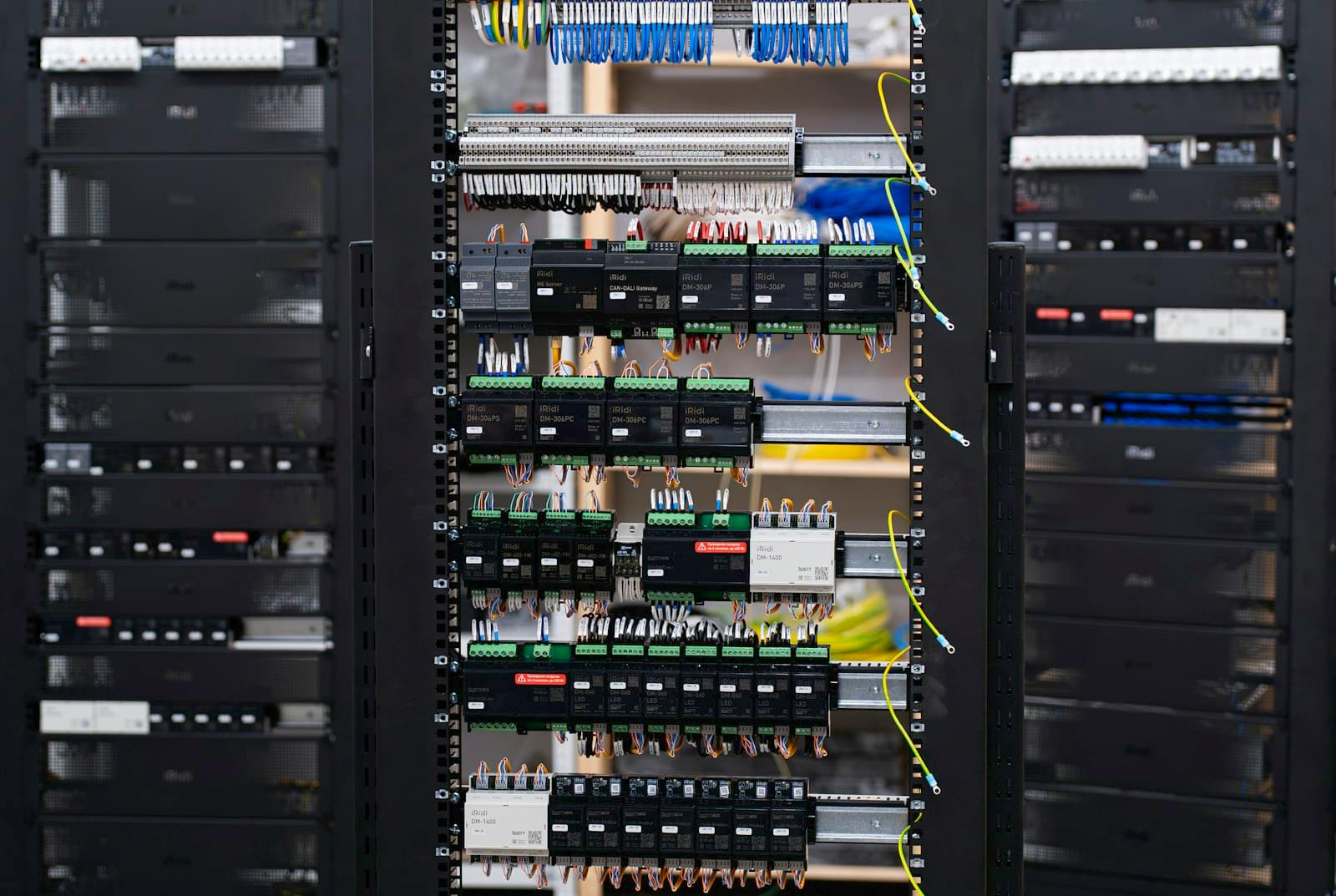 Open cabinet of DIN-rail communication and automation modules with labelled wiring