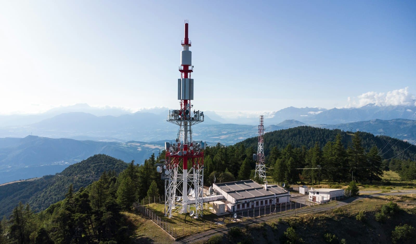 Telecom tower with antennas on a forested hilltop